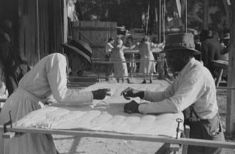Making a quilt from surplus commodity cotton in Georgia, October 1941